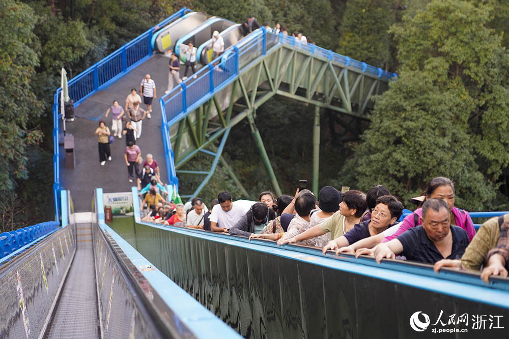 10月15日，浙江省臺州市仙居縣神仙居景區(qū)，游客通過自動扶梯輕松爬山。人民網(wǎng) 章勇濤攝